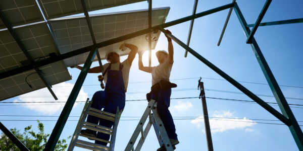 Working,Hard:,Solar,Panels,On,Metallic,Carcass,Mounting.,Two,Workers Working,Hard:,Solar,Panels,On,Metallic,Carcass,Mounting.,Two,Workers
